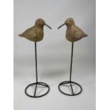 A pair of ceramic decoy type ducks with over painted detail and mounted on a metal post, height