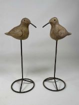 A pair of ceramic decoy type ducks with over painted detail and mounted on a metal post, height