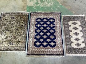 A Pakistani rug, 178 x 128cm, and two further rugs. (3)