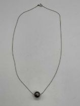 A Tahitian pearl (diameter approx 9.5mm) suspended on a fine white metal chain stamped 750, length
