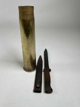 A WWII German bayonet, length 37cm from point to muzzle insert, and a WWI shell case with Chinese