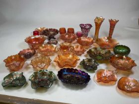 A large collection of carnival glass including floral decorated bowls and vases.