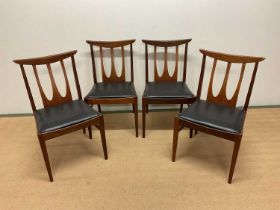 G-PLAN; a mid 20th century set of four teak dining chairs with black seat pads, height 80cm.