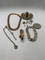 A small group of costume jewellery including two crucifix pendants, pendant on chain, brooch,