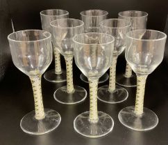 † MICHAEL JAMES HUNTER; a set of eight opaque twisted stem wine glasses, with snapped pontil to base