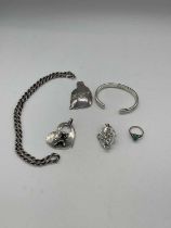 A quantity of silver jewellery marked 925 including brooches, a bangle, a chain and pendant and