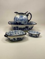 An Art Nouveau inspired blue and white pottery toilet jug, bowl, soap dish and stand, and small dish