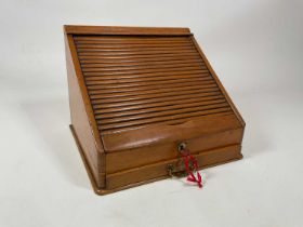 A tambour front light oak desk tidy with single drawer to base, height 32cm, width 42cm, depth