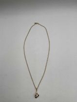 A 9ct yellow gold chain suspending a 9ct yellow gold and pearl calla lily drop pendant, length of