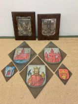 Two silver plated coats of arms mounted on oak plaques, larger 44 x 33cm, together with five