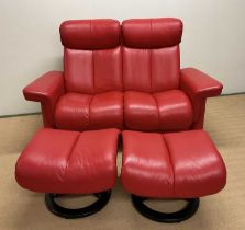STRESSLESS LEGEND; a red leather upholstered reclining two seater settee with twin matching