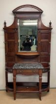 A Victorian mahogany hallstand, with central bevelled mirror, flanked to each side by five brass