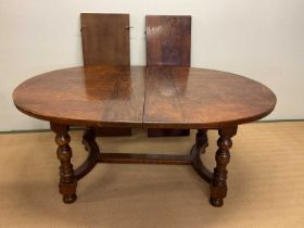 An oak dining table with two leaves, height 76cm, unextended width 180cm, extended width 268cm,