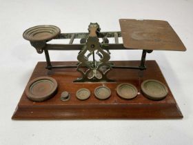 SAMPSON MORDAN & CO; a set of brass England Inland Postal scales with weights set to mahogany
