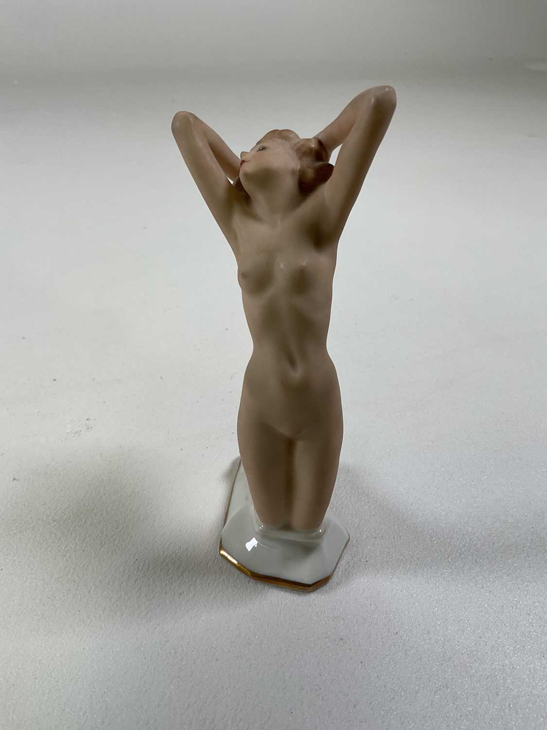 A German Hutschenreuther porcelain figure of a female nude kneeling with her arms and back