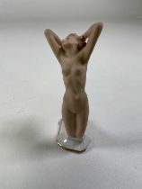 A German Hutschenreuther porcelain figure of a female nude kneeling with her arms and back
