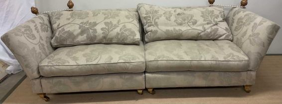 Three drop end sofas, comprising a four seater and a pair of two seaters, upholstered in linen