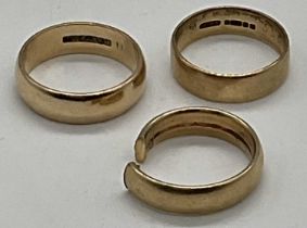 Three 9ct yellow gold wedding bands (one cut), combined approx 16.25g.