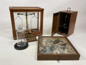 A collection of various scientific items including a set of brass chemical balance scales in glass