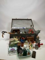 A vintage suitcase full of collectors' items including kitchenalia, tins, miniature scent bottles,