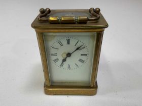A circa 1900 French brass carriage clock, the white enamelled dial set with Roman numerals, height