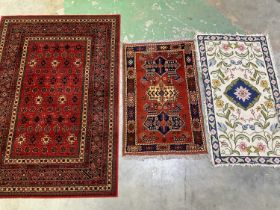 A Keshan rug, 200 x 140cm, and two other rugs. (3)