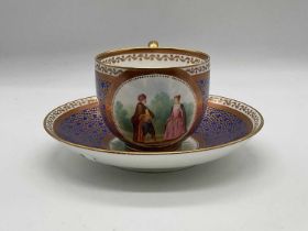 An early 19th century vermicelli pattern cabinet cup and saucer, each hand painted with a vignette