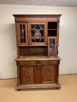 A French oak buffet comprising three sections with glazed top over two drawer base and cupboard (