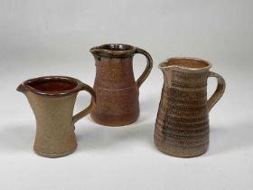 MUCHELNEY POTTERY; two stoneware jugs with decorated rims and impressed marks, the largest height