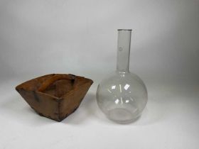 A large ten litre Pyrex round bottom flask, height 49cm, also with a naive wooden trug, height 18cm
