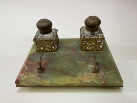 An early 20th century green onyx brass mounted inkstand with twin lidded pots, width 21cm.