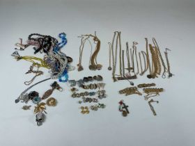 A large collection of costume jewellery, to include gold tone bracelets, gold plated chains and