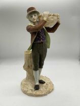 ROYAL WORCESTER; a figure of a young man carrying a lattice work basket upon his left shoulder, with