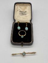 A matched suite of yellow metal and opal jewellery comprising a ring, size G 1/2, a bar brooch,