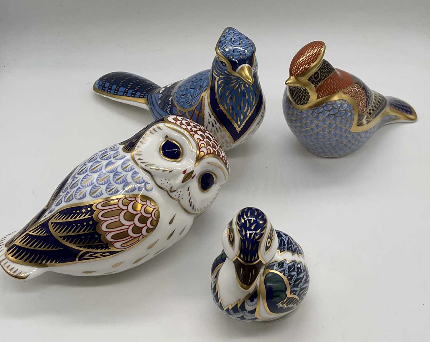 ROYAL CROWN DERBY; paperweights bird models comprising 'Blue Jay' with gold stopper, 'Waxwing'