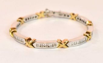 An 18ct white and yellow gold diamond line bracelet set with a mixture of round brilliant cut and