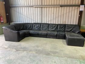 A mid 20th century 1970s Danish black leather modular sofa which separates into seven sections,