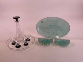 An Art Deco style decanter set including a glass tray, four glasses with black bases and a