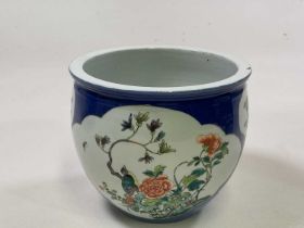 A 19th century Chinese porcelain Famille Verte jardinere with white vignettes on a blue ground,