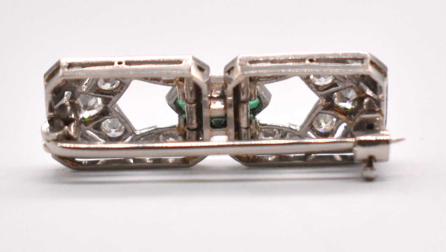 An Art Deco white metal emerald and diamond brooch set with three emeralds to the central raised - Image 2 of 6