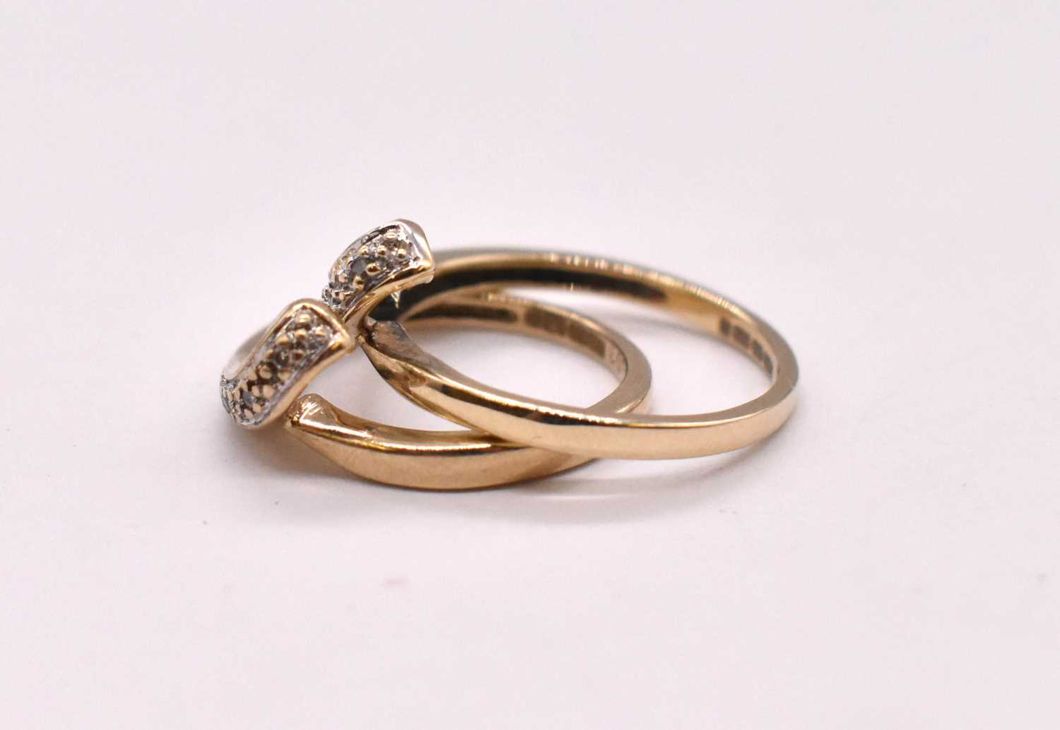 A pair of 9ct yellow gold diamond set swept wishbone designed rings, combined approx. 3.75g. - Image 3 of 3