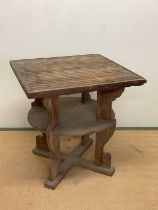 An early 20th century table on four supports and a single shelf, constructed from teak understood to