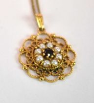 A 9ct yellow gold pierced garnet and pearl set pendant, suspended on a 9ct yellow gold fine link