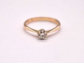 An early 20th cenury 18ct yellow gold diamond solitaire ring, the claw set round brilliant cut stone