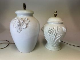 Two Italian white ceramic glazed lamp bases, the taller with stylised lion head, the other floral