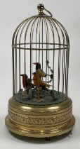 An early 20th century triple bird automaton singing musical birdcage with scroll detail to the