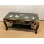 A contemporary Chinese lacquered coffee table, height 47cm, width 103cm.