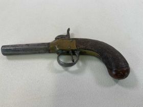 A late 18th/early 19th century percussion cap pistol with adzed walnut stock and octagonal barrel,