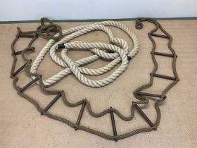 A large mooring rope, length approx 9 metres long with a girth of 7cms, and a scaling rope ladder,