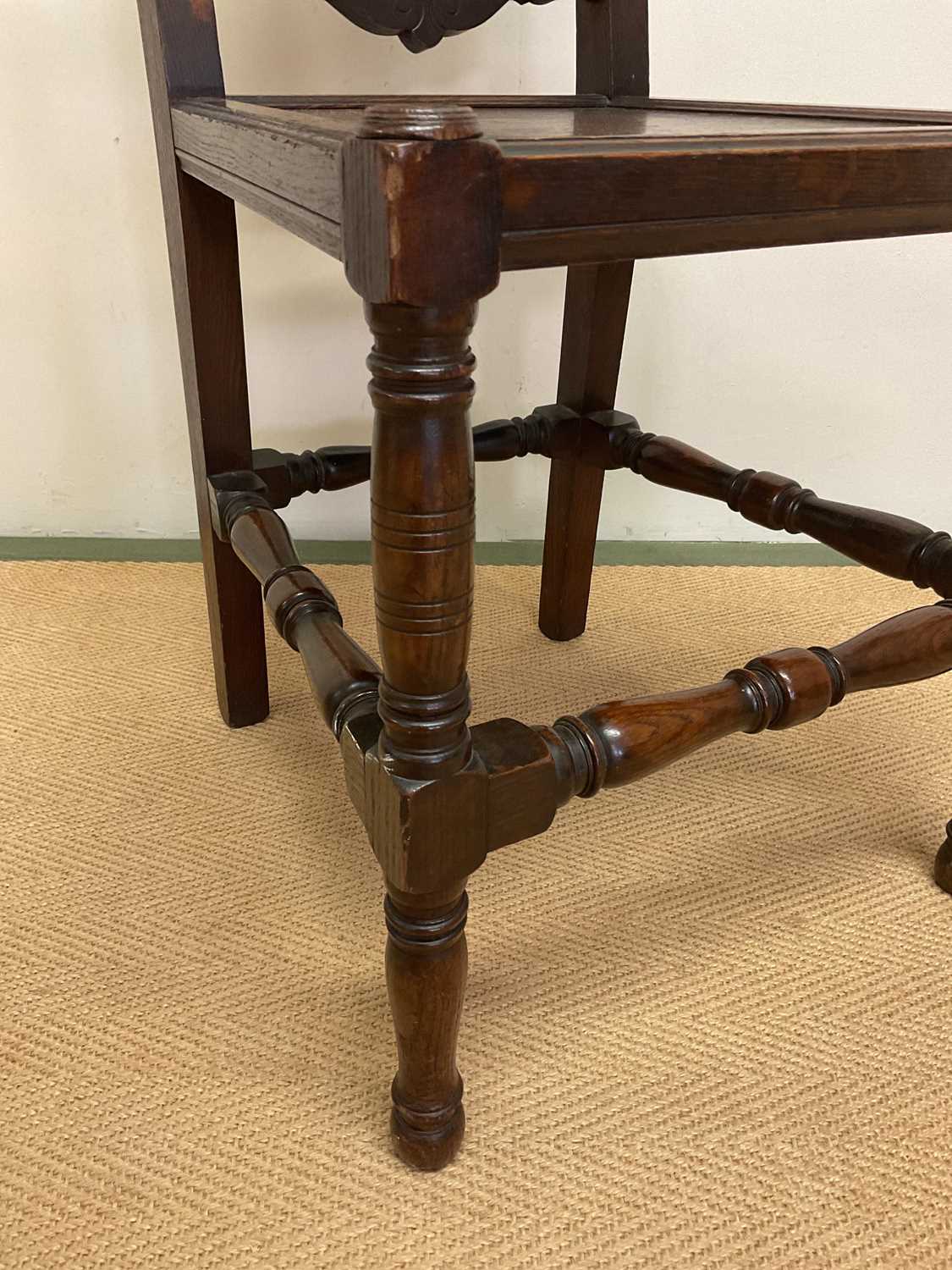 A 19th century oak panel back side chair with panel seat and carved central motif of a flower on the - Image 2 of 4